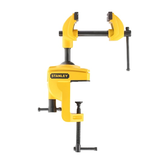 Yellow STANLEY bench vise with adjustable jaws and mounting clamps, used for securely holding workpieces.