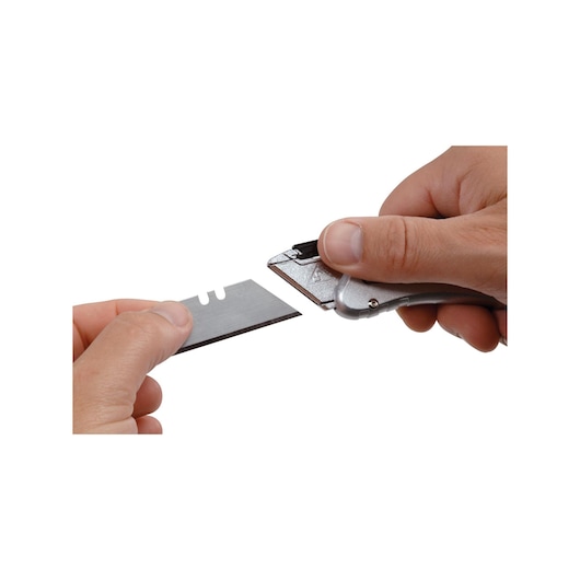 STANLEY 10-810 utility knife and blade held in hands, close-up photo on white background.