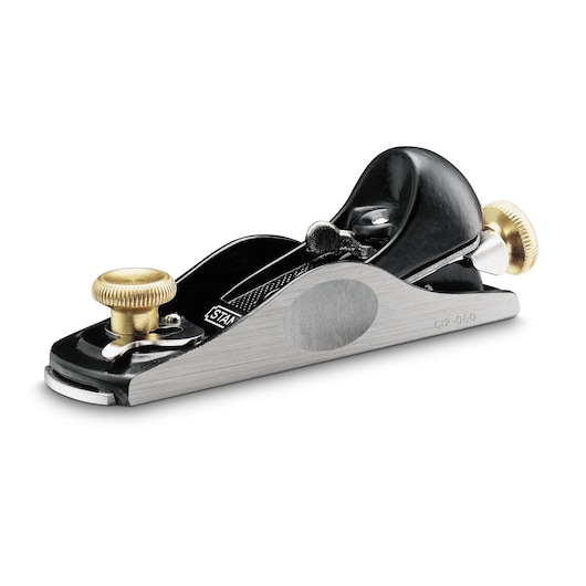 STANLEY 12-060 block plane with metal body and brass knobs, designed for precise woodworking tasks.