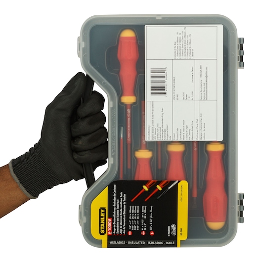 Stanley 65-980 insulated screwdriver set in plastic case, front angle, held by gloved hand.