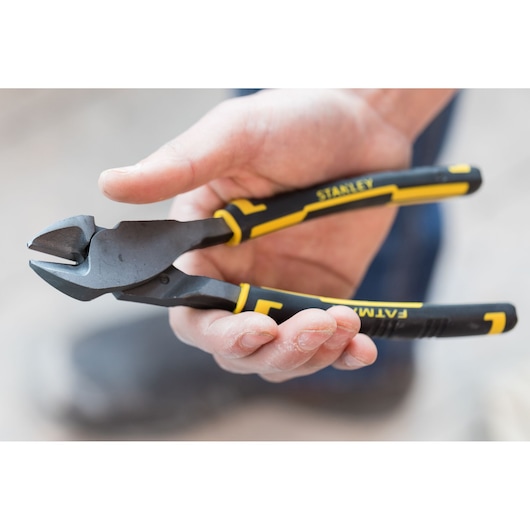 STANLEY 89-861 diagonal cutting pliers with black and yellow handles held in a hand, close-up view.
