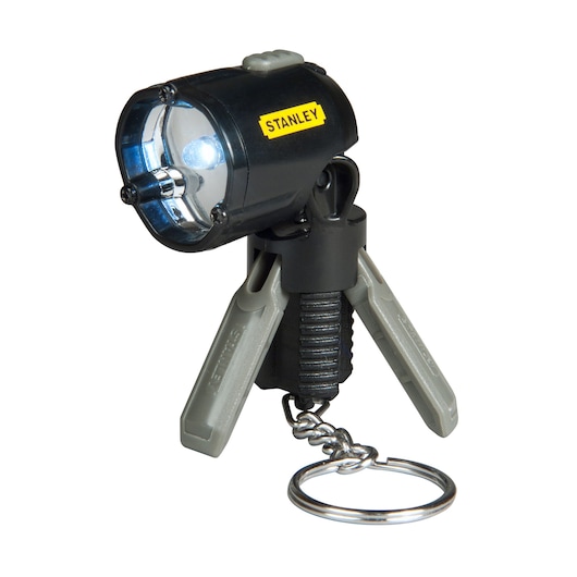 STANLEY 95-113 mini LED flashlight keychain with tripod legs, black and gray, front view on white background.