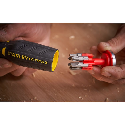STANLEY FMHT0-62690 screwdriver handle with yellow interior and red bit holder with multiple screwdriver bits.