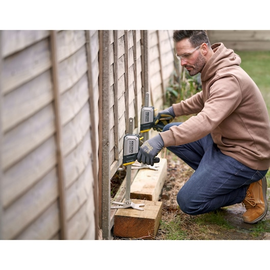 STANLEY FMHT83550-1 clamp being used to secure a wooden fence panel outdoors.