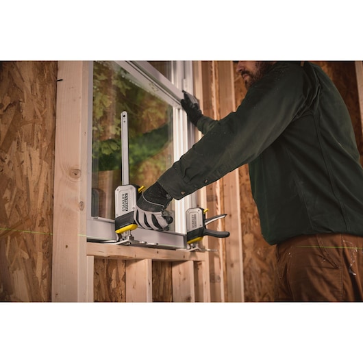 STANLEY FMHT83550-1 photography of carpenter using quick clamp on window frame installation.