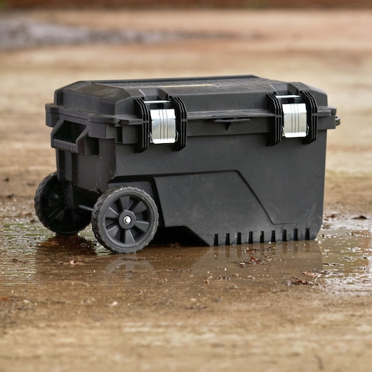 STANLEY FMST1-73601 black rolling toolbox with metal latches, photography, outdoor angle.