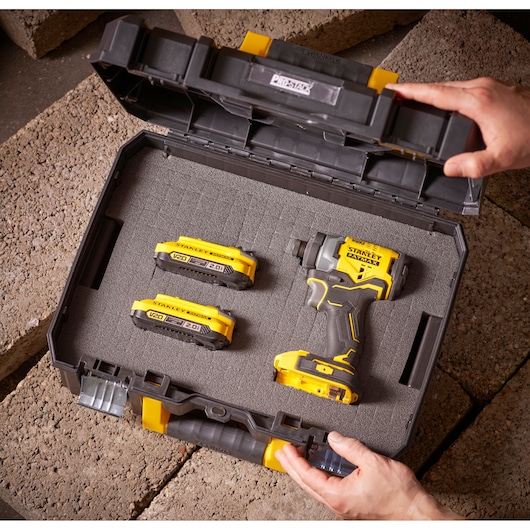 STANLEY FMST1-75502 photography of impact driver kit in black and yellow storage case, top angle.