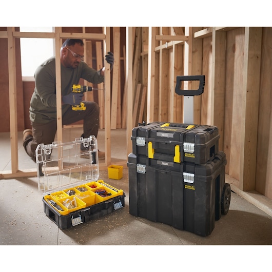 Photo of STANLEY FMST1-80101 modular toolboxes, including an open organizer and stackable rolling cases at a construction site.