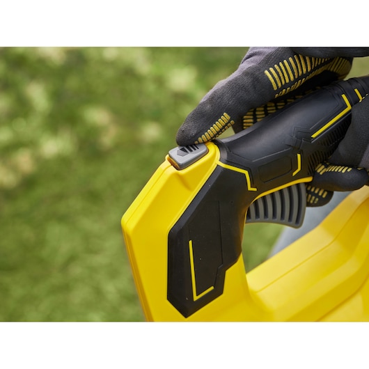 STANLEY SFMCBL730M1 blower handle close-up showing ergonomic black and yellow design, outdoor context.