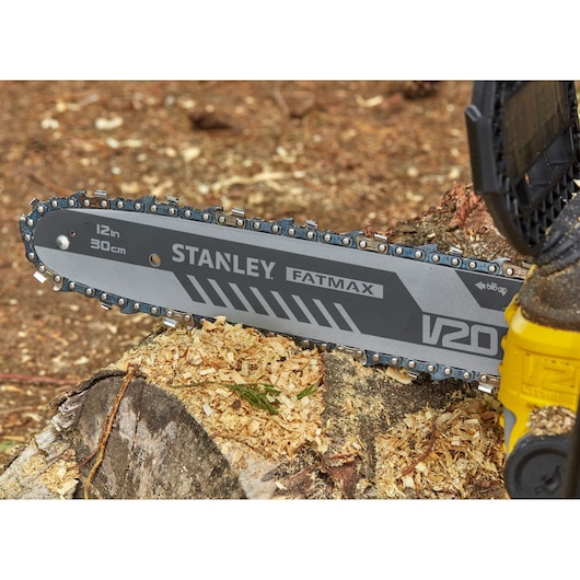 Photo of STANLEY SFMCCS630B chainsaw blade on tree stump, FATMAX V20, 12in/30cm bar, close-up view.