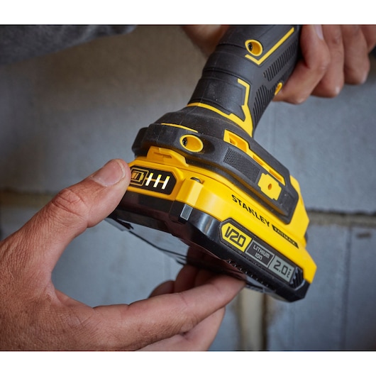 Photo of STANLEY SFMCD715D1A cordless drill, close-up of yellow and black handle and V20 lithium-ion battery.