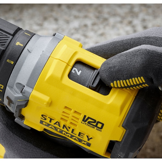 Photo of STANLEY SFMCD715D1A cordless drill close-up showing yellow V20 FATMAX body and gear selector.