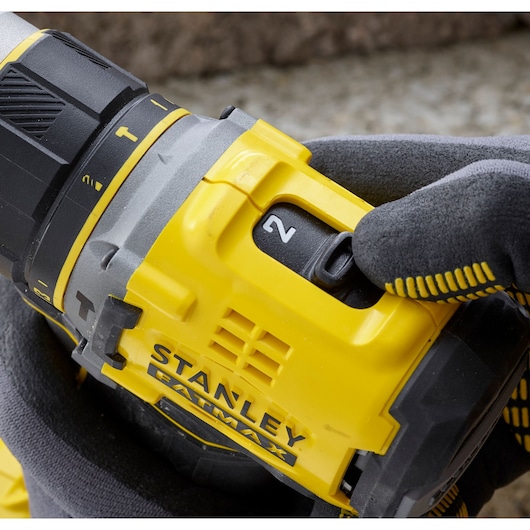 Photo of STANLEY SFMCD721DR2 drill showing yellow body, speed selector and FATMAX branding in close-up.