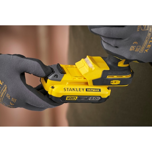 Photo of STANLEY SFMCD726D2K cordless drill being held, showing V20 Fatmax battery close-up.