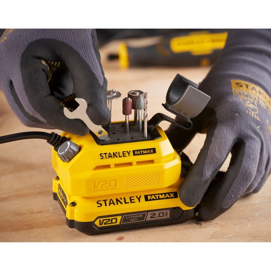 STANLEY SFMCE030B rotary tool with drill bits and accessories inserted, close-up on workbench.