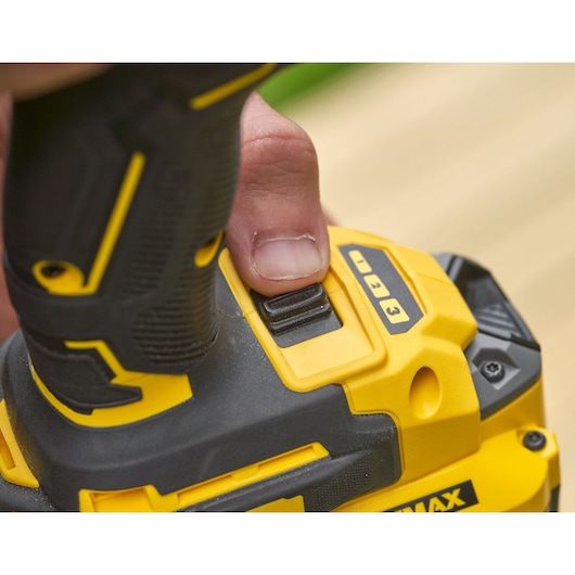 Close-up photo of DeWalt tool handle, SKU SFMCF820D2K, showing speed setting switch and grip details.