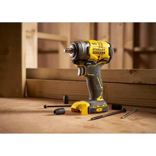 STANLEY SFMCF910B impact driver with black and yellow design shown on workbench with screws and bits.