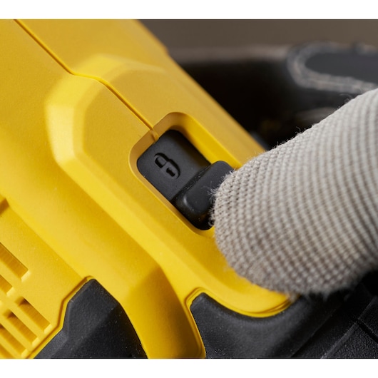 STANLEY SFMCG400M1S close-up photography of yellow tool lock switch with gloved hand.