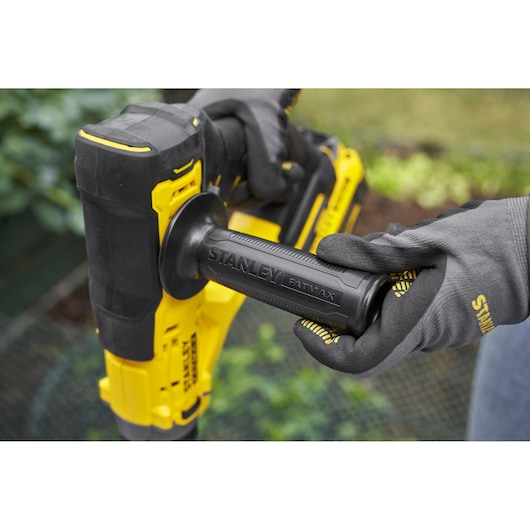 STANLEY SFMCGA75B rotary hammer close-up, black and yellow handle with STANLEY FATMAX branding held by gloved hands.
