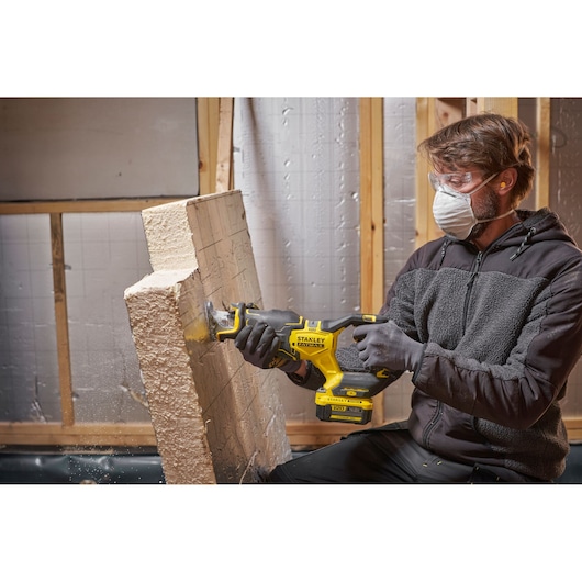 Photo of STANLEY SFMCS311B-XJ reciprocating saw, used to cut insulation board during construction.