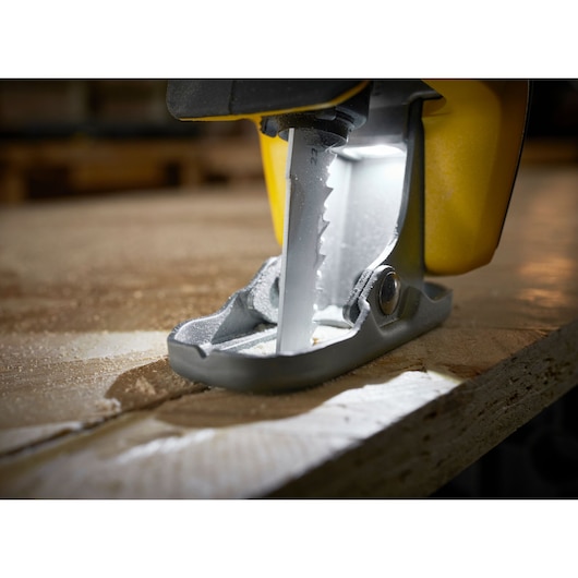 STANLEY SFMCS311B-XJ jigsaw blade cutting wood with LED light, close-up angle.