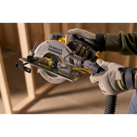 Stanley SFMCS500B circular saw in use, close-up with dust extraction hose connection.