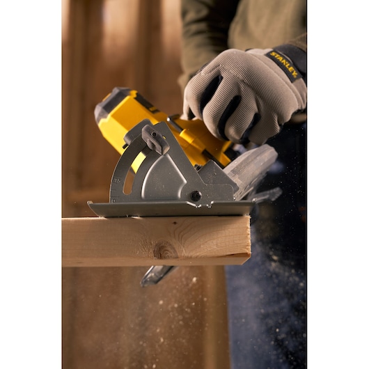 STANLEY SFMCS500B cordless circular saw in use cutting wood, close-up photography.