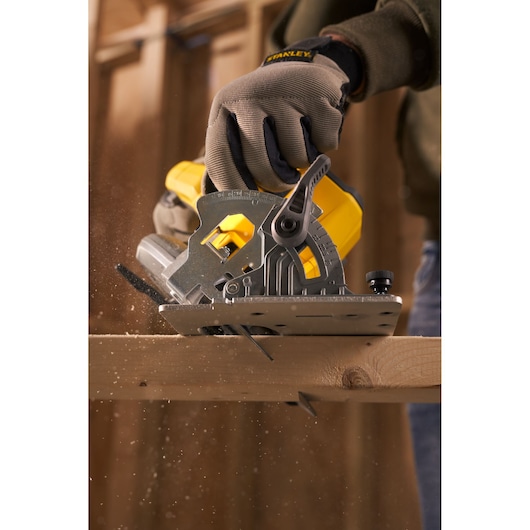 STANLEY SFMCS500M1S circular saw cutting wood, close-up action photography, yellow and gray tool.