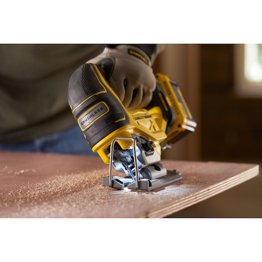 Photo of STANLEY SFMCS650B 18V FATMAX V20 brushless jigsaw cutting wood, close-up, tool in use.