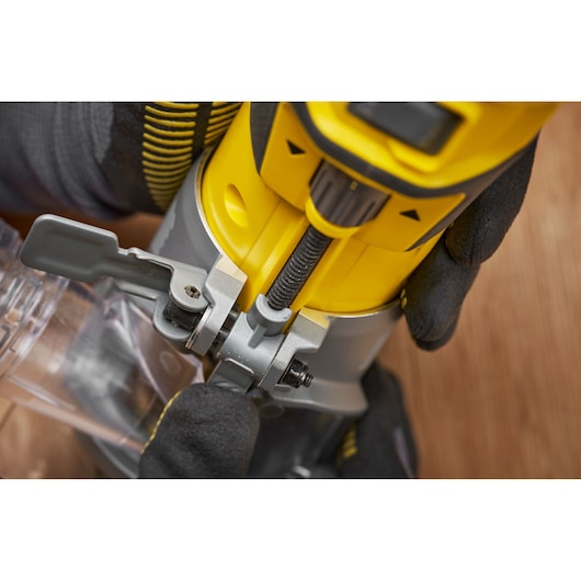 Photo of STANLEY SFMCW400B wood router adjustment mechanism, close up view showing yellow and gray details.