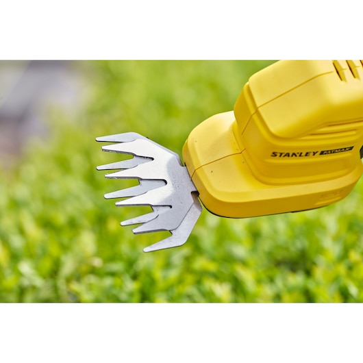 STANLEY STCSS20B garden shear close-up, yellow handle and metal blades over green grass.