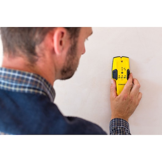STANLEY STHT0-77404 yellow wall scanner, handheld, detecting studs in plaster wall.
