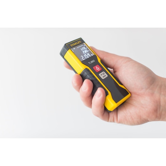 STANLEY STHT1-77032 yellow laser distance measurer held in hand, front view, photography.