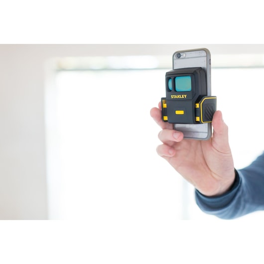 STANLEY STHT1-77366 photography tool attached to smartphone, held in hand, black with yellow accents.